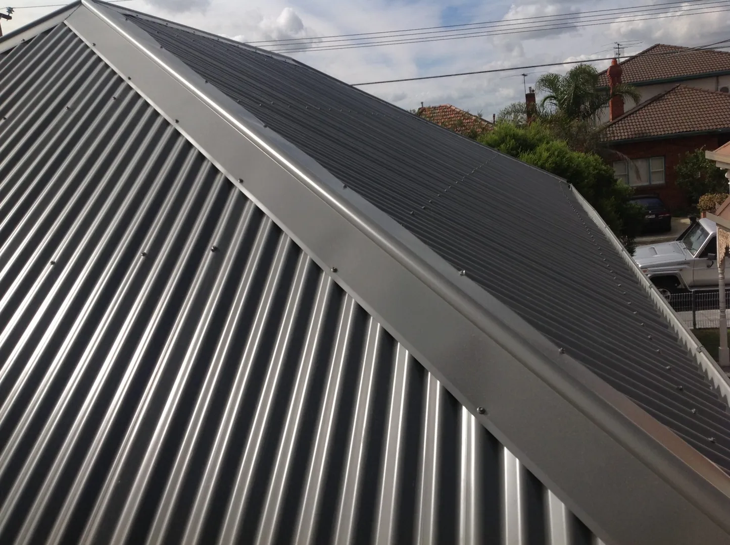 Close-up of corrugated metal roof with solar panels.